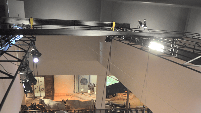 A large room with a lot of lights hanging from the ceiling.