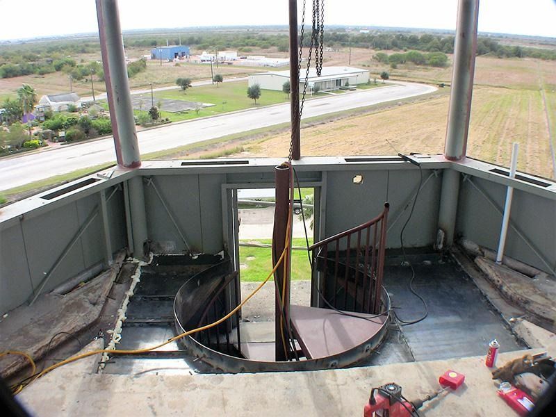 There is a spiral staircase in the middle of a building.