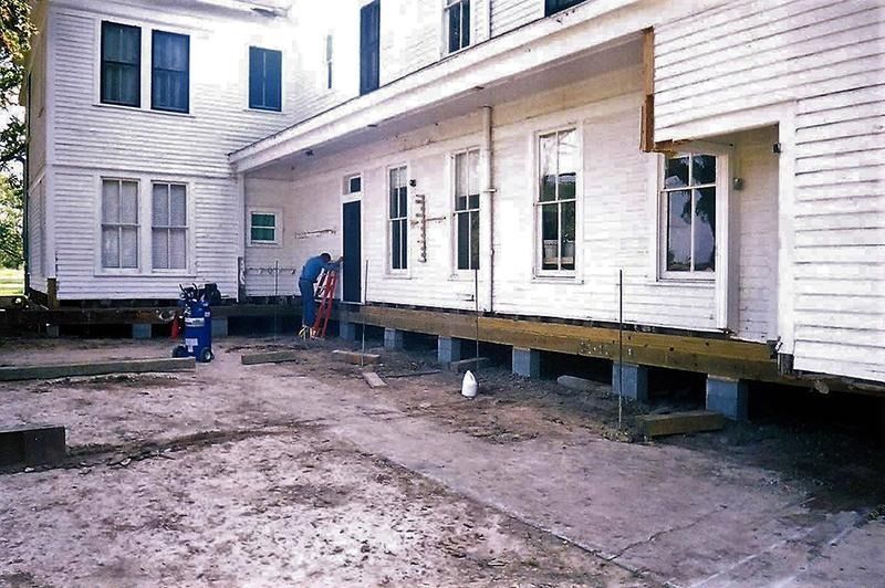 A large white house is being moved to a new location