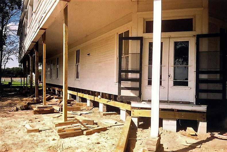 A white house with a porch under construction
