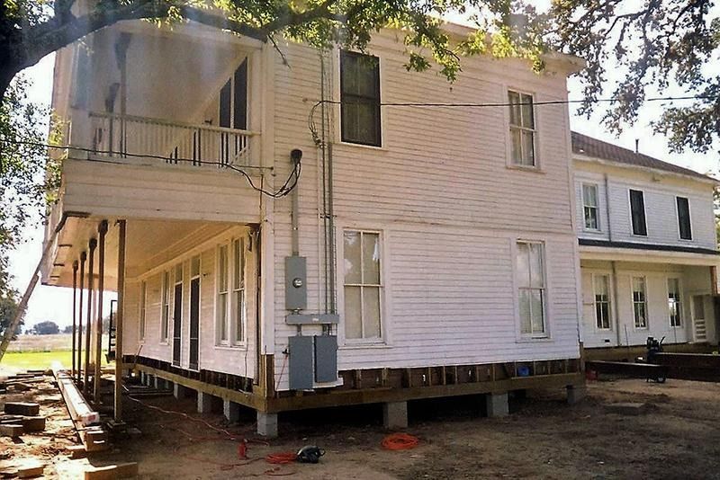 A white house is being moved to a new location