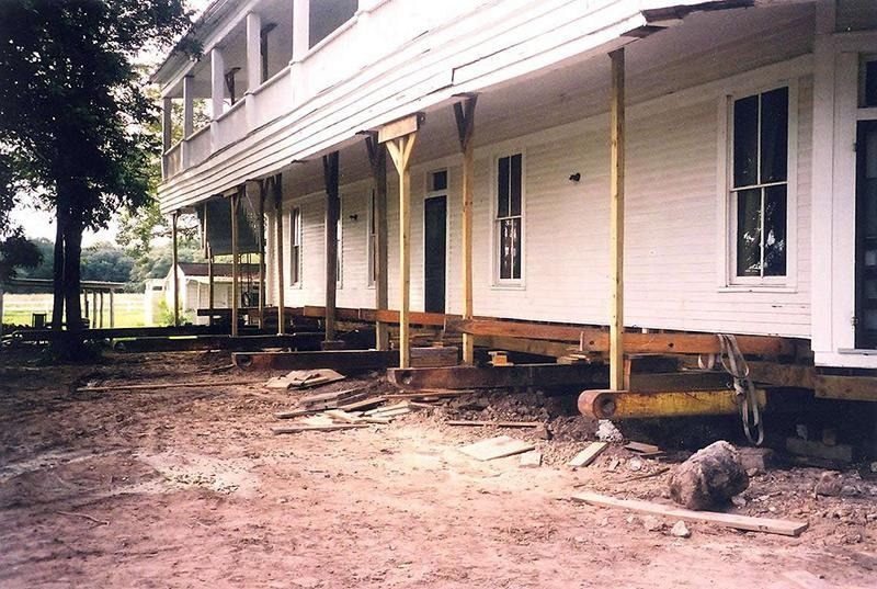 A large white house is being moved to a new location