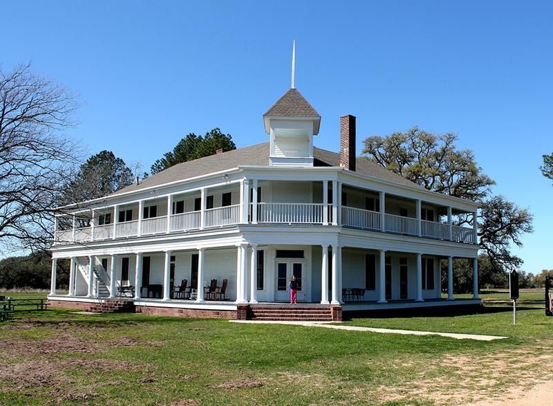 A large white house with a tower on top of it