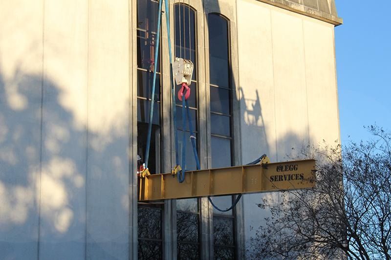 A building with a crane attached to it and a sign that says public services