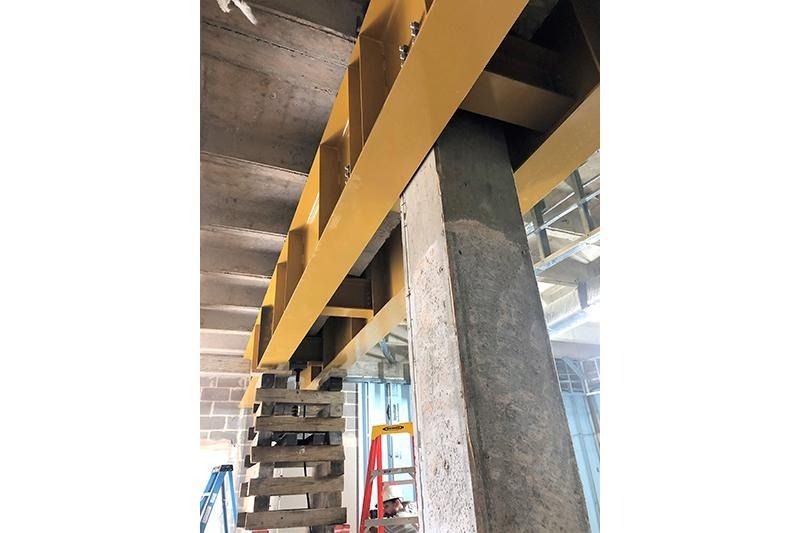 A close up of a metal structure in a building under construction.