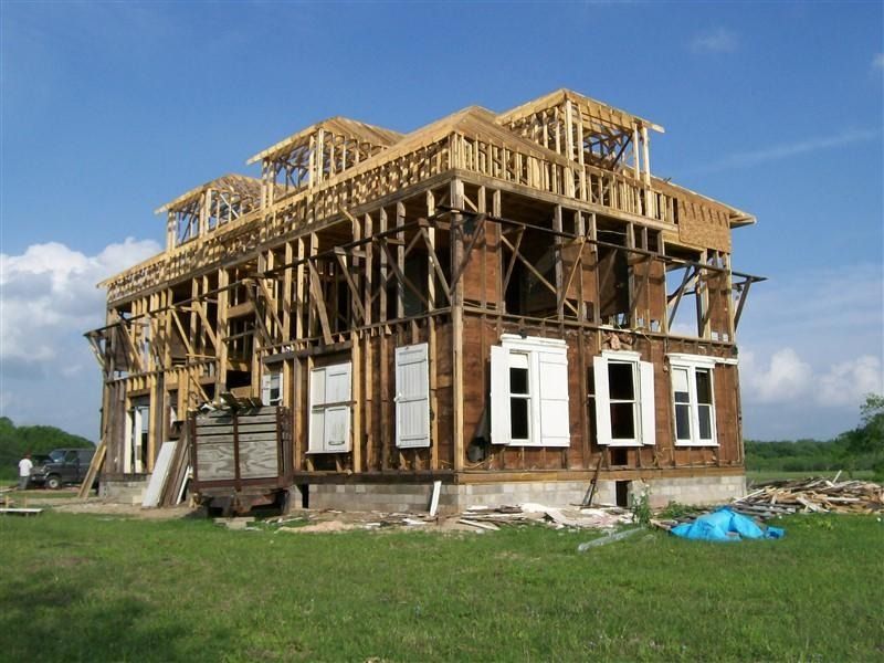 A house is being built in the middle of a grassy field