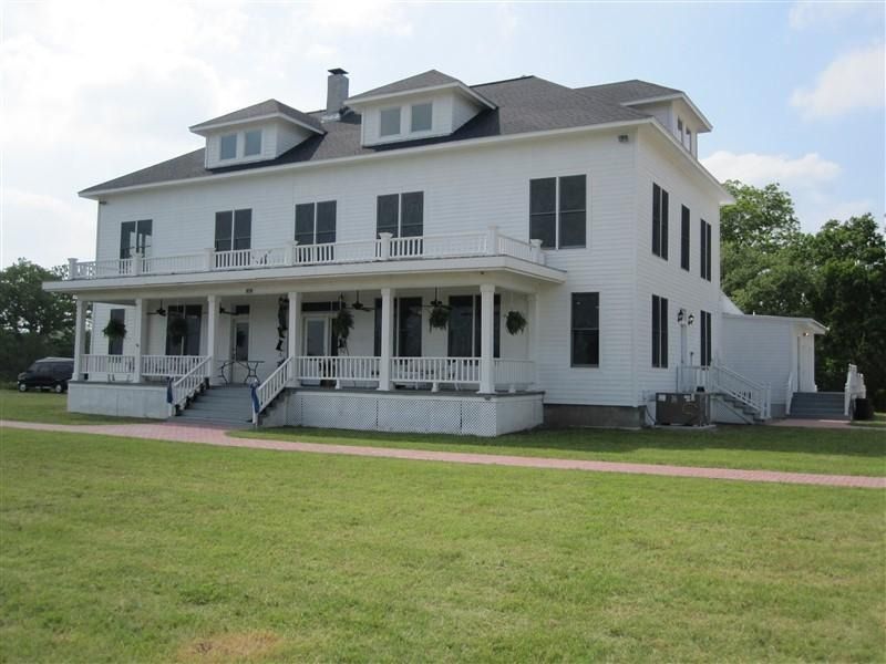 A large white house with a large porch
