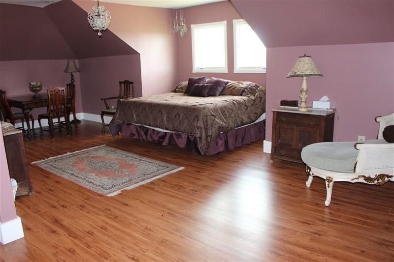 A bedroom with purple walls and a large bed