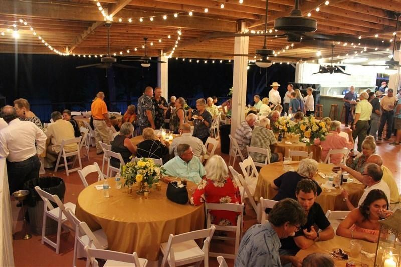 A large group of people are sitting at tables in a large room.