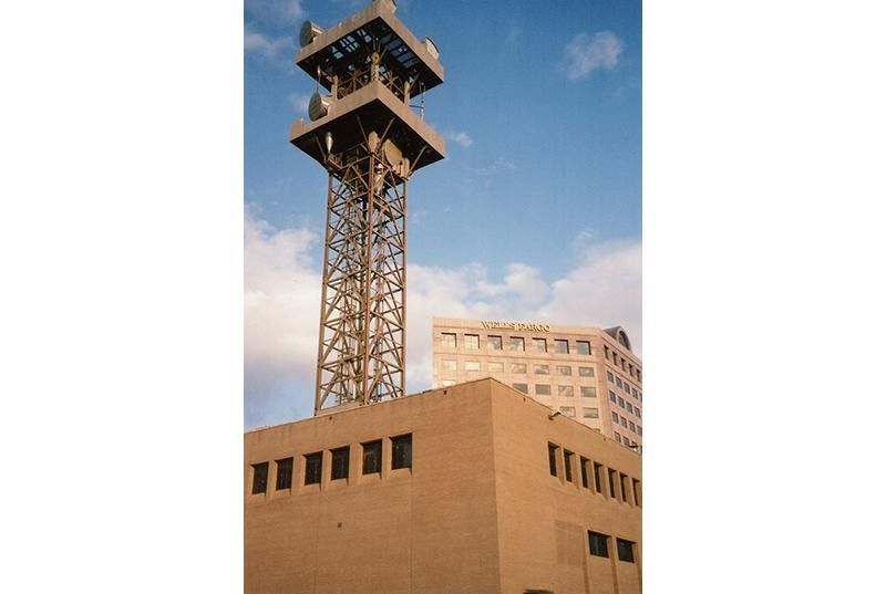 A tall tower is sitting on top of a building.