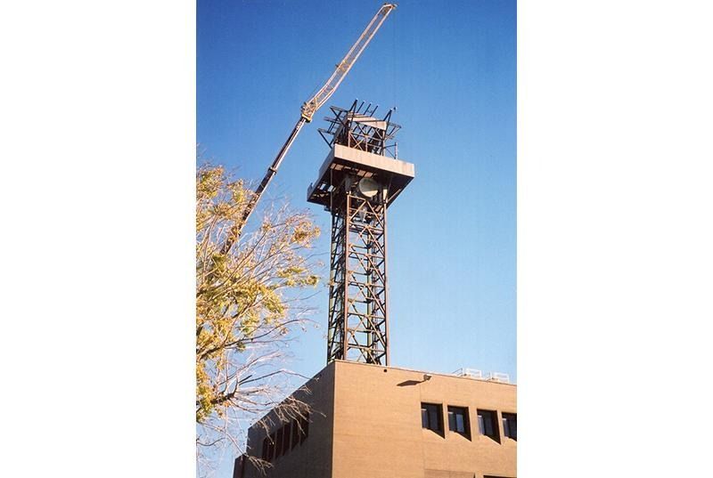 A large tower is being built on top of a building
