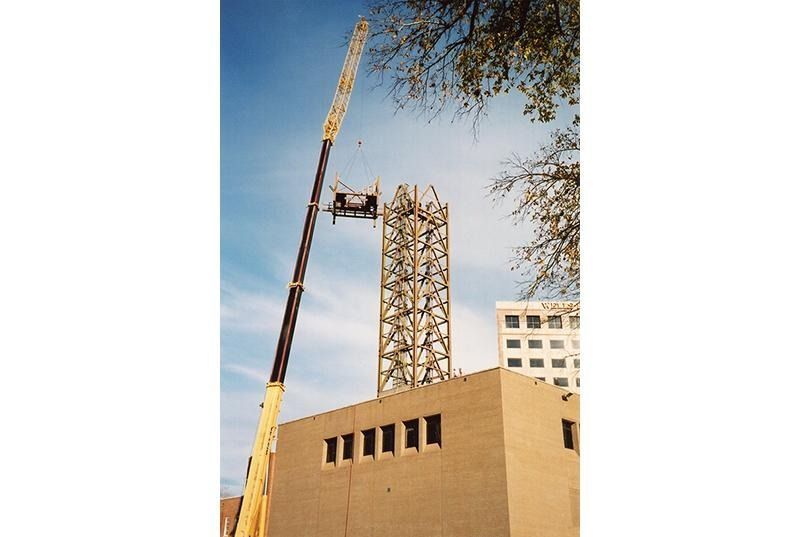 A tall building with a crane on top of it