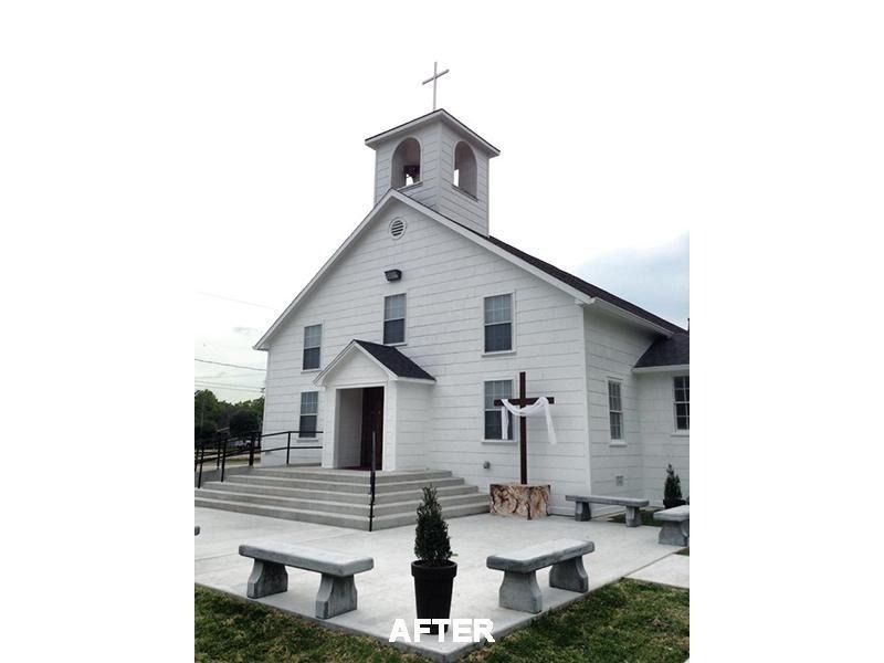 A white church with a cross on top of it