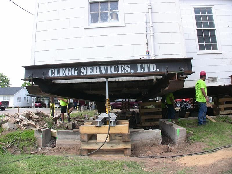 A clegg services ltd sign is on the side of a building