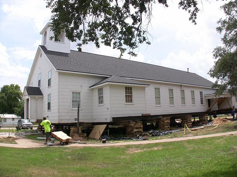 A large white church is being moved to a new location