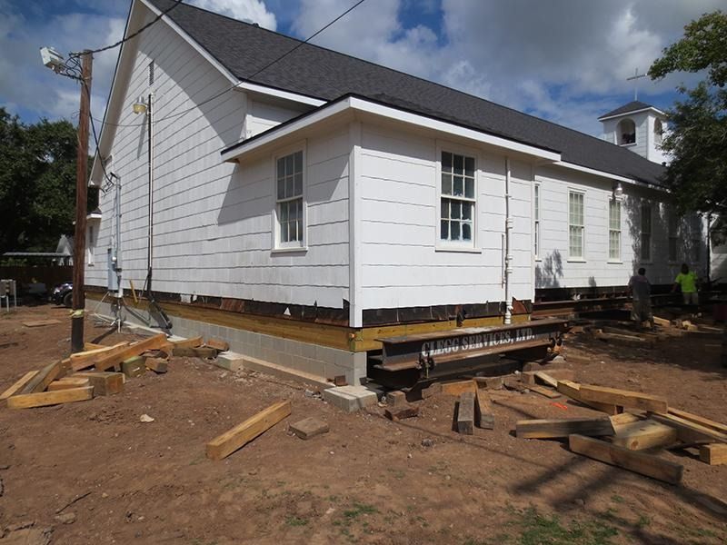 A white house is being moved to a new location