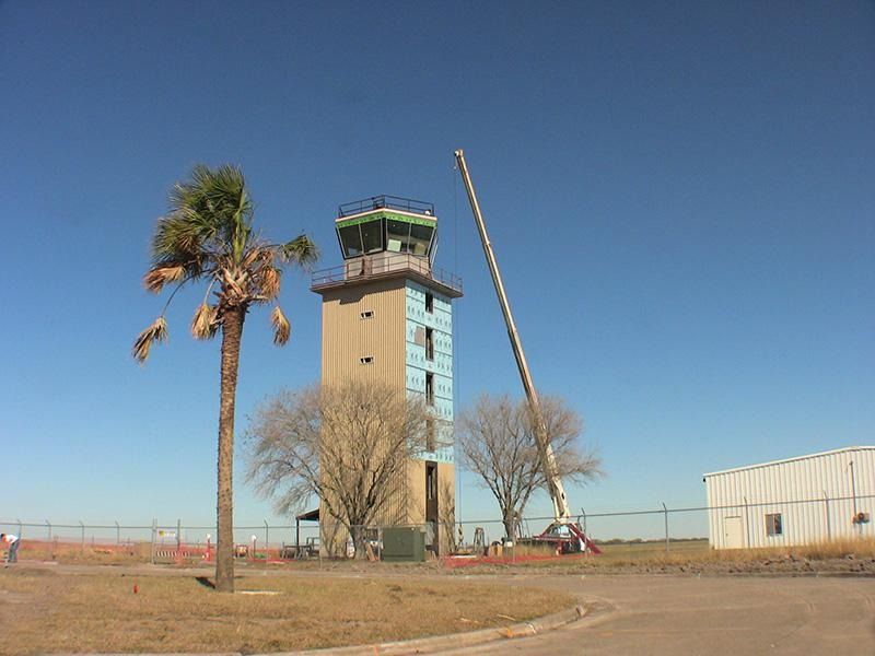 A tower with a palm tree in front of it