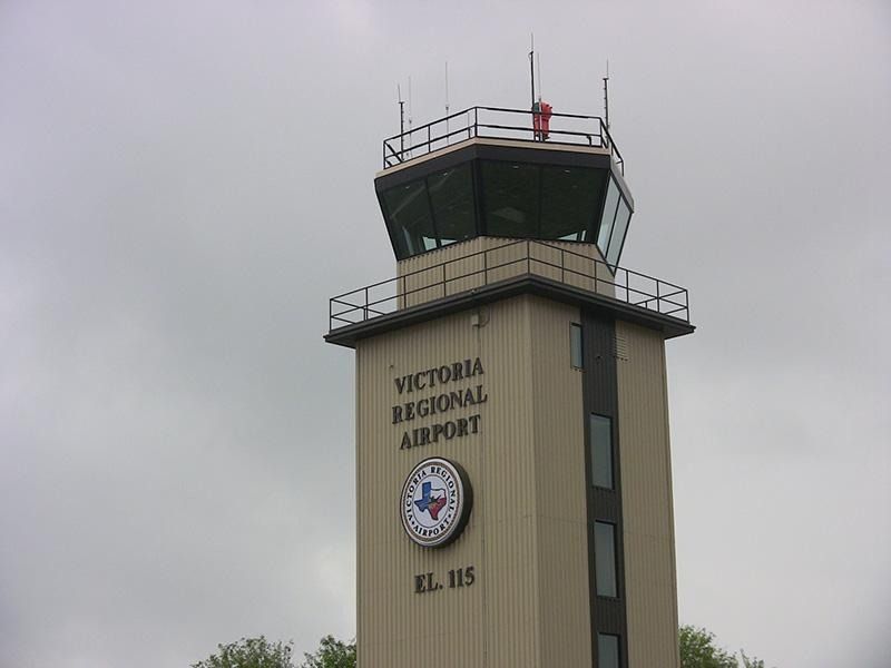 A victoria regional airport tower with a clock on it