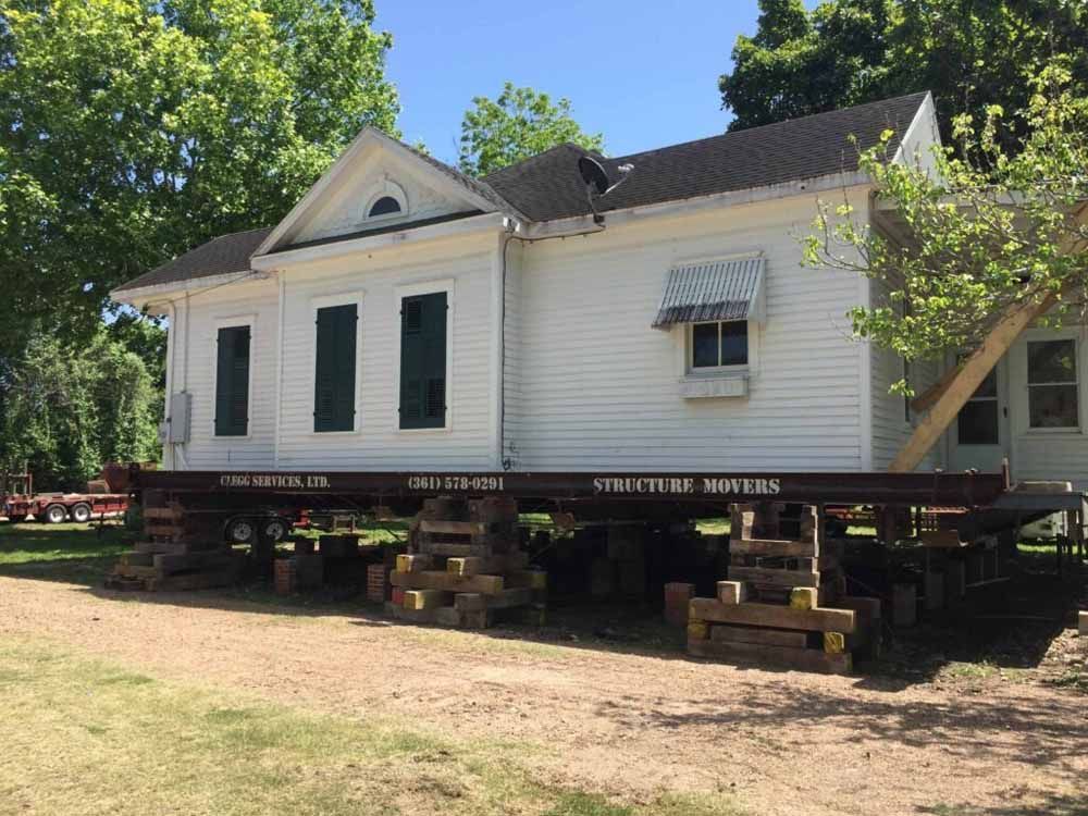 A white house is being moved to a new location.