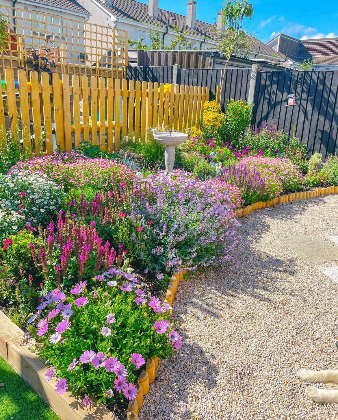 A patio with a table and chairs in front of a house.