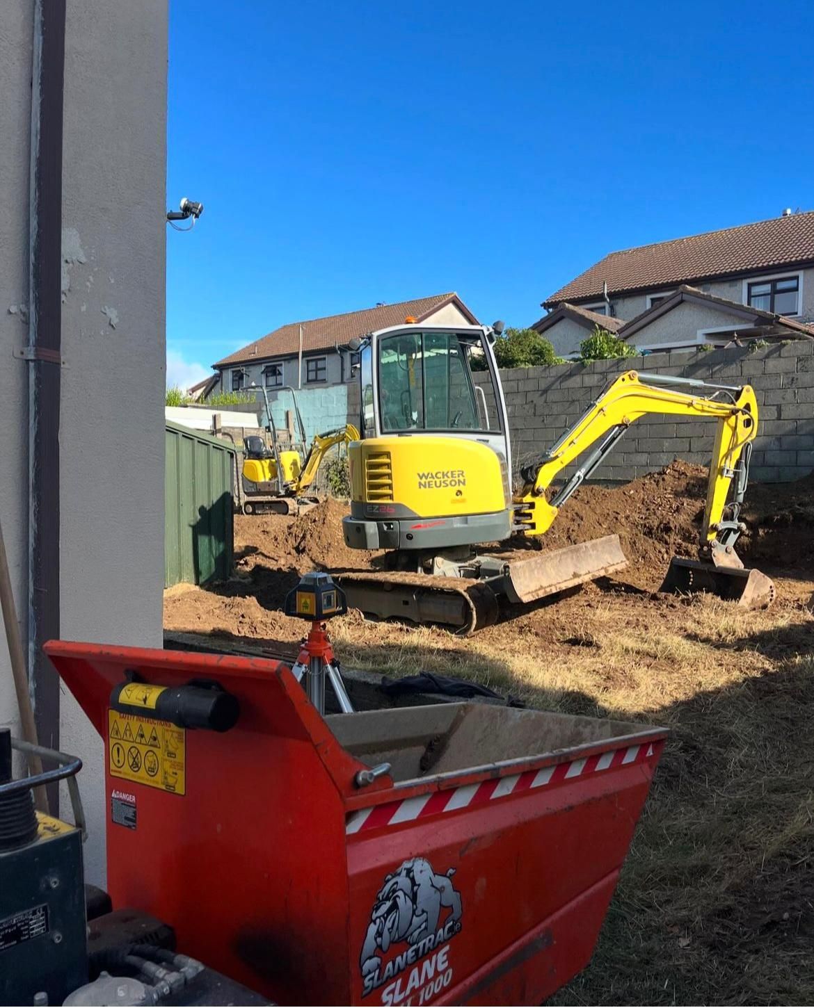 A patio with a table and chairs in front of a house.