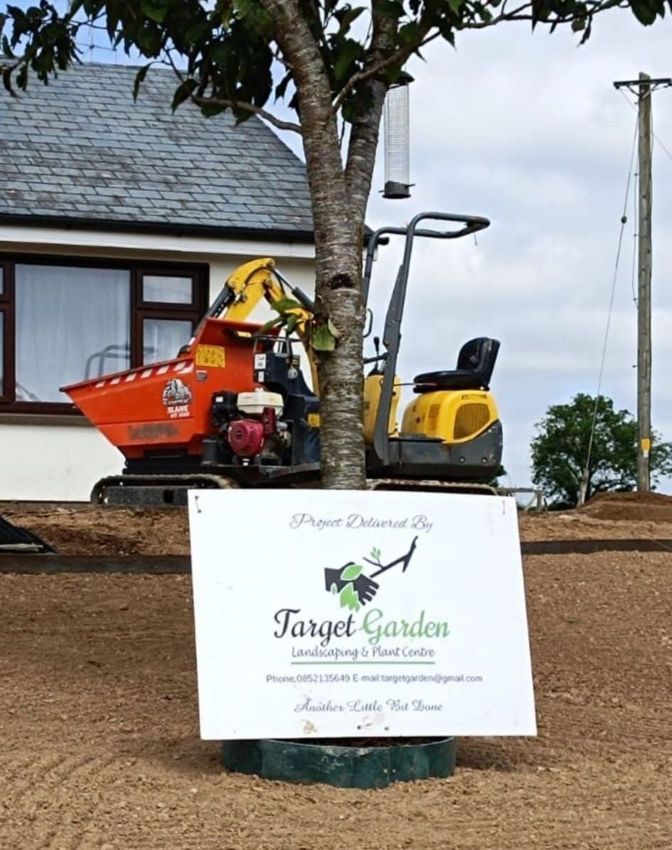 A sign that says target garden is in front of a house