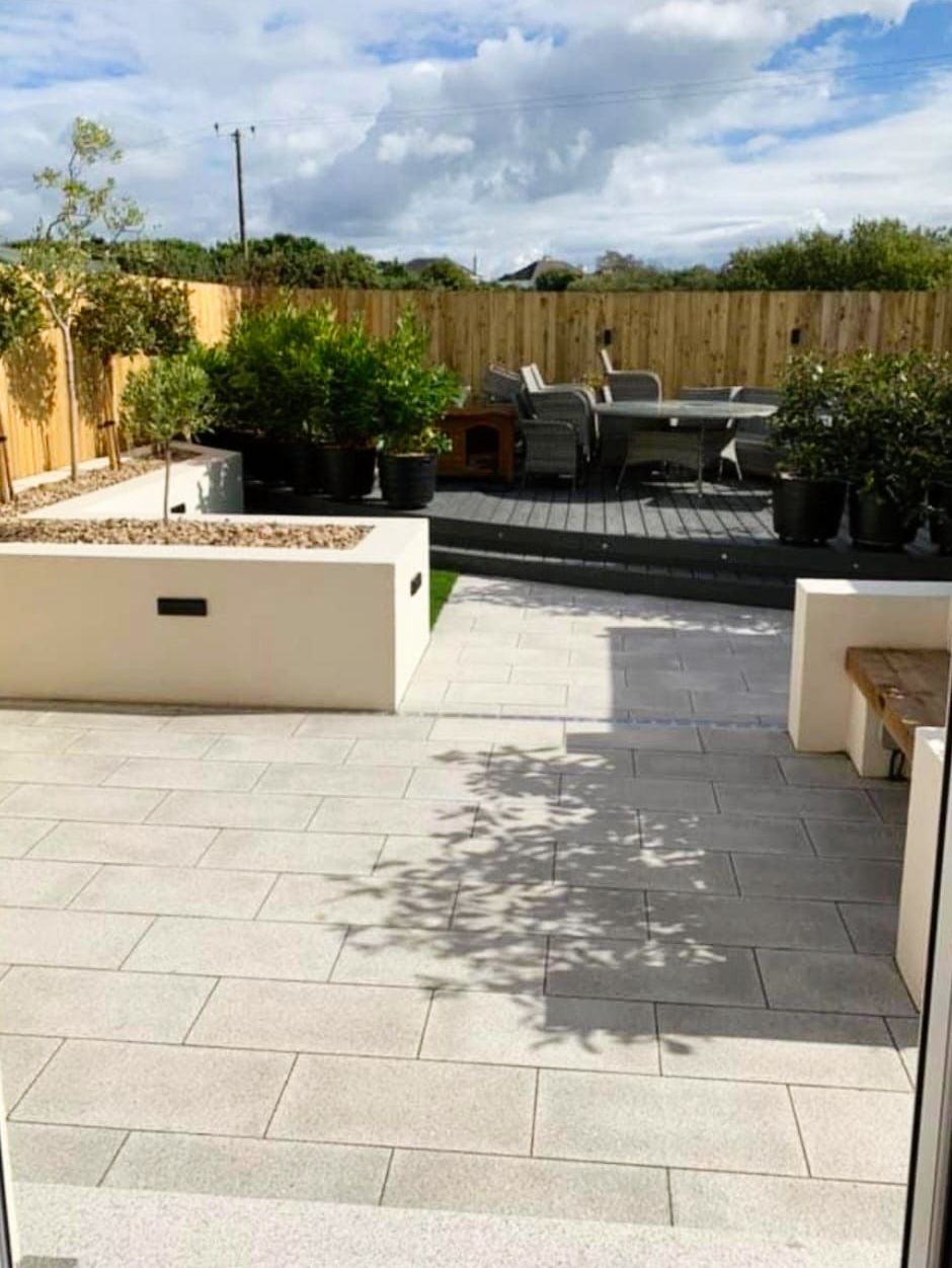 A patio with a table and chairs and a bench.