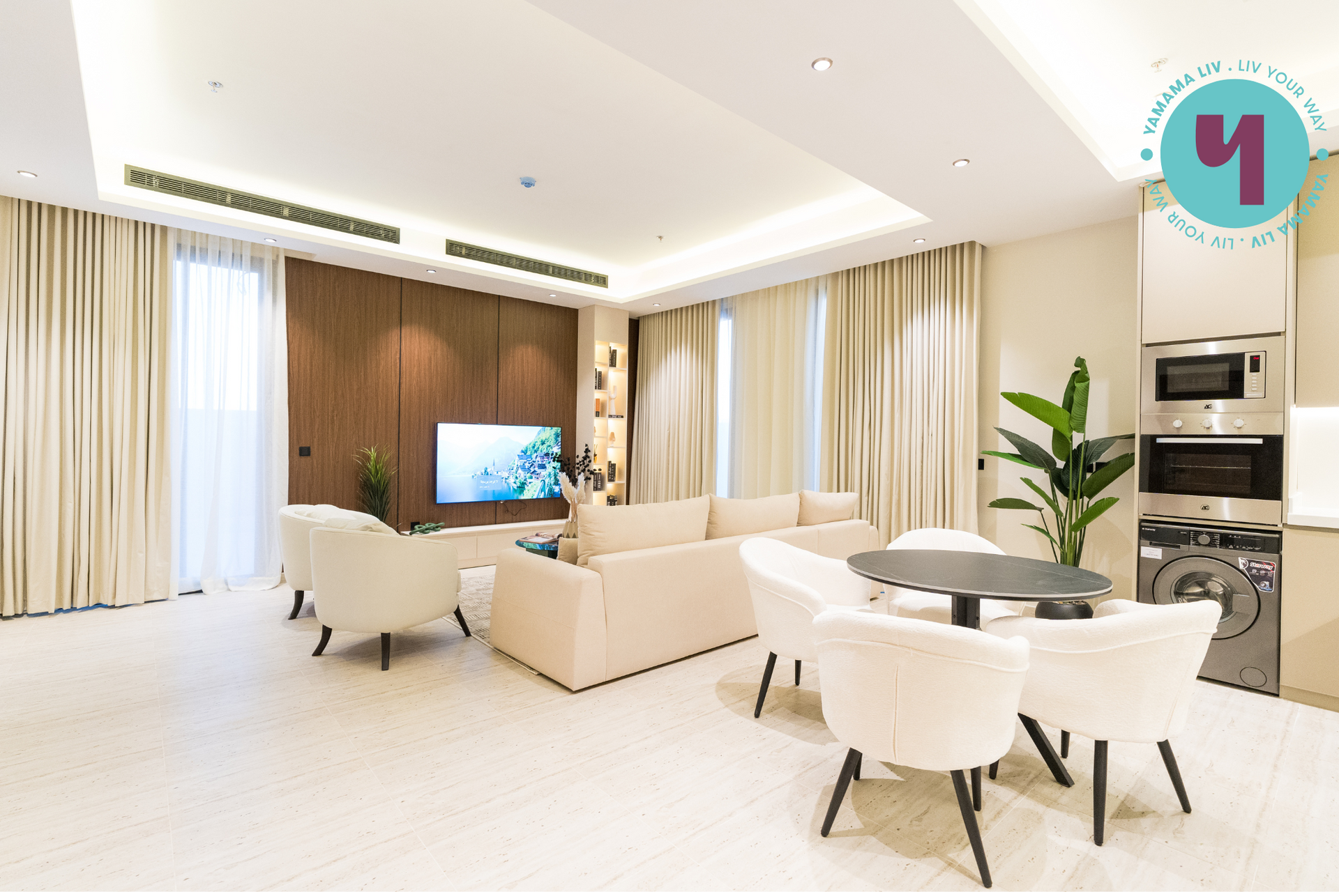 A living room with a couch , chairs , a table and a television.