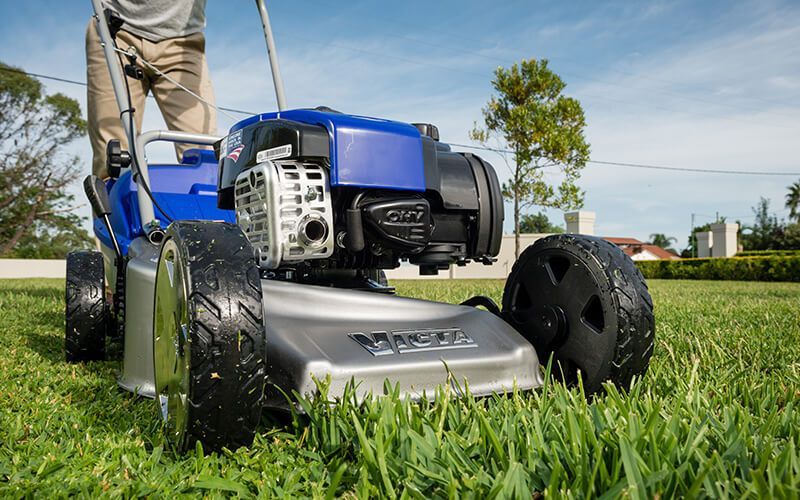 A Victor Lawn Mower is Sitting on a Blue Surface — Jacksons Mower Centre in Mackay, QLD