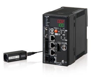 Macchina industriale nera con telecamera incorporata, diverse porte e display LED.