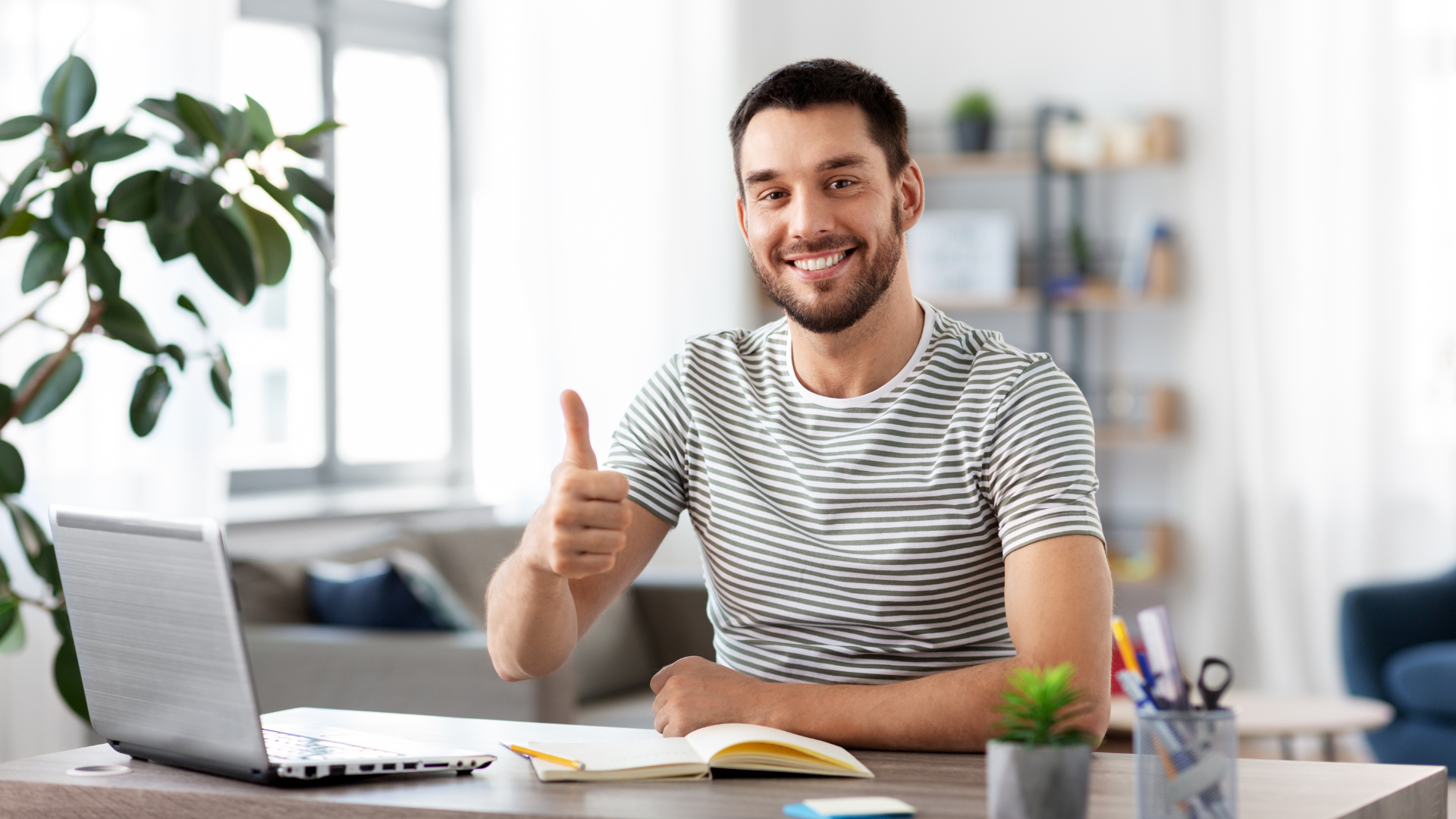 A remote worker gives a thumbs up as he experiences the benefits of remote work security