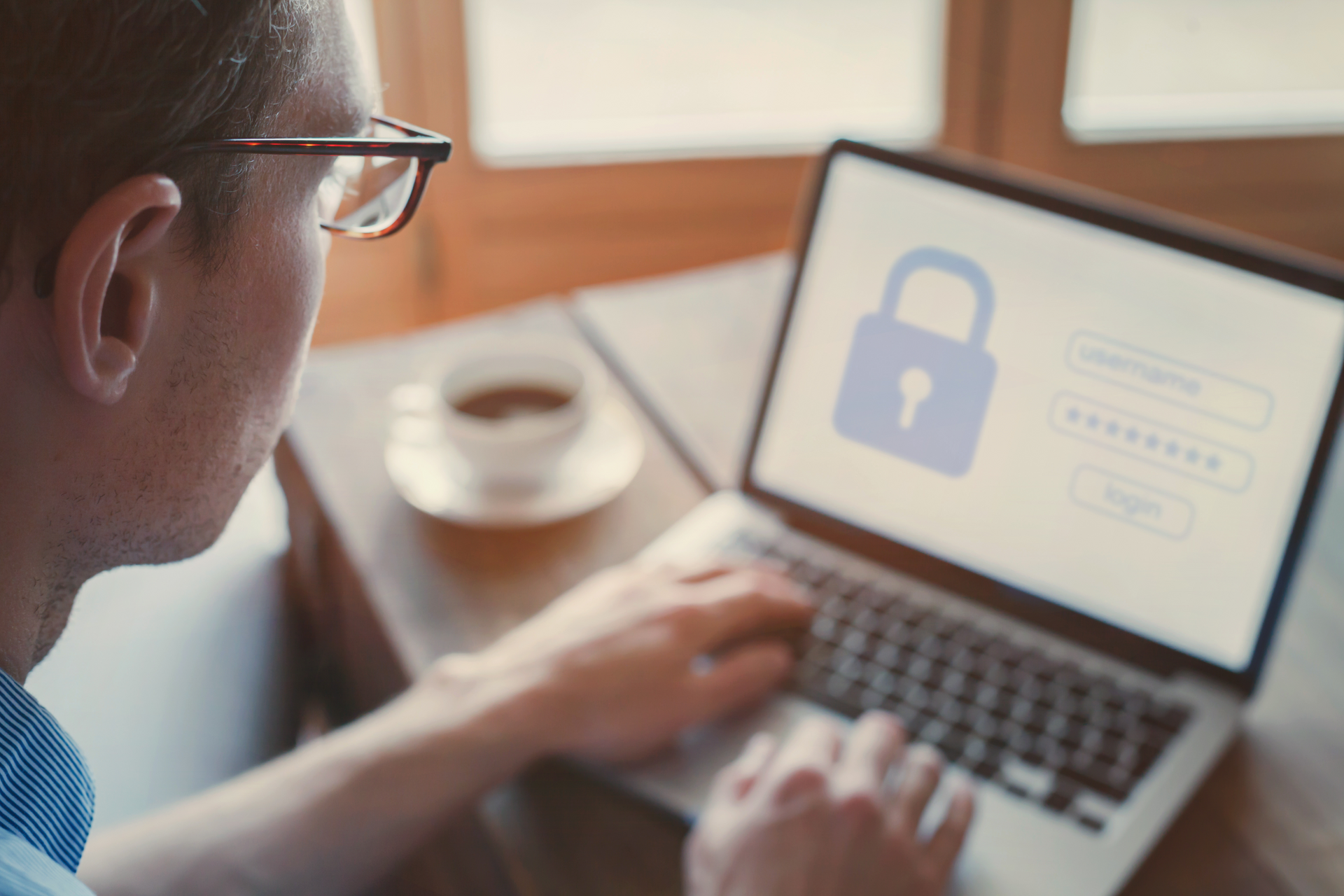 A man using a dedicated password manager to secure his laptop.