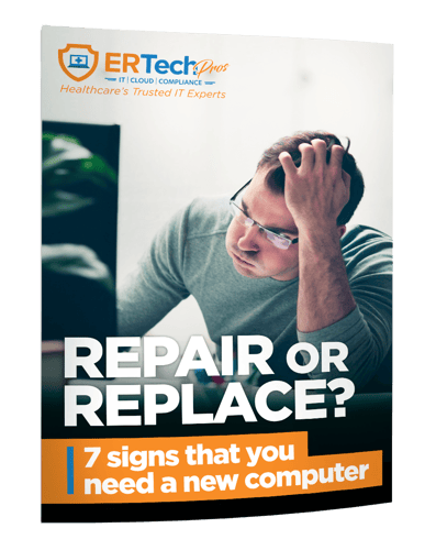 A man is sitting in front of a computer with his hands on his head.