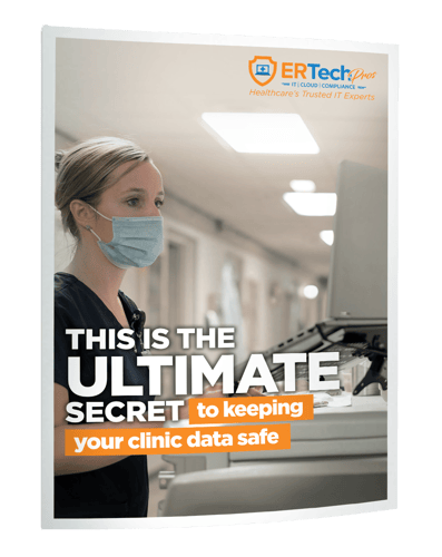 A nurse wearing a mask is standing in a hospital hallway.