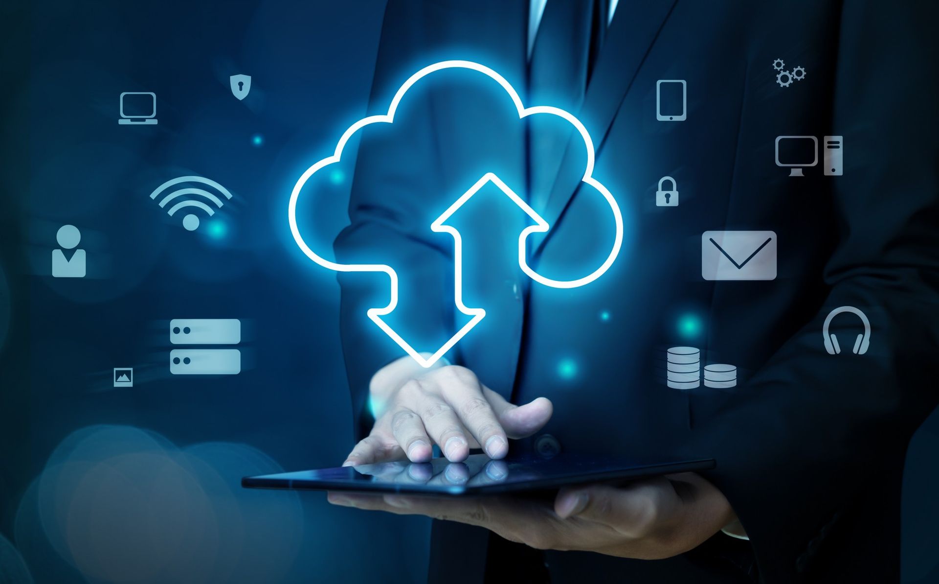 A man in a suit is holding a tablet with a cloud icon on it.