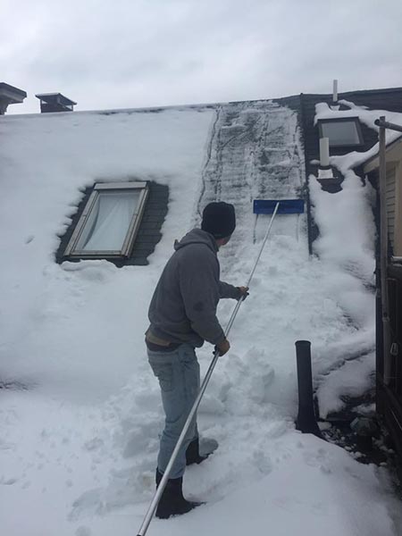 Man removing the ice in his house — Power Washing Services in New Galilee, PA