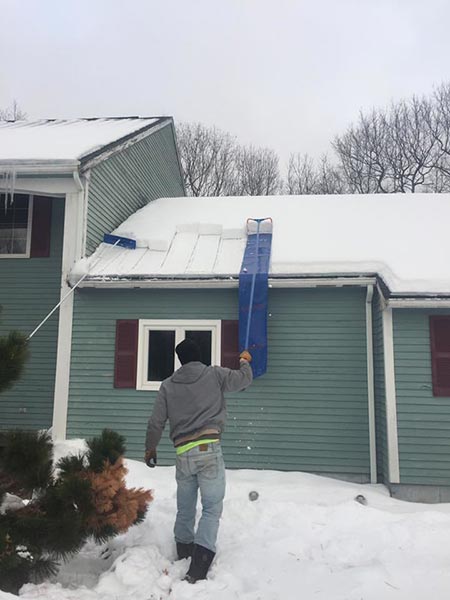 Man cleaning his house roof — Power Washing Services in New Galilee, PA