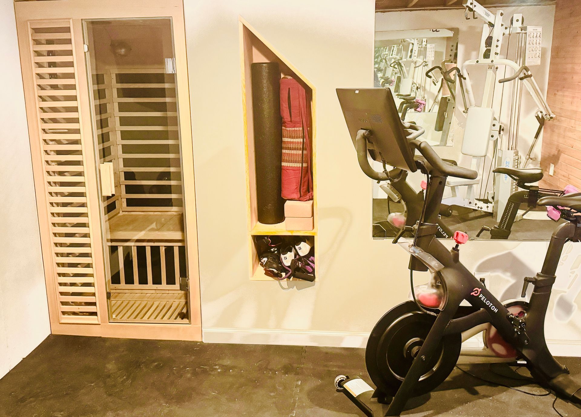 A bicycle is sitting in a room next to a sauna.