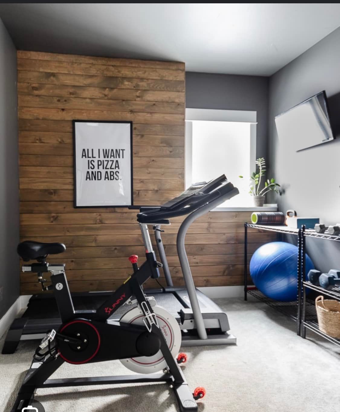 A gym with a sign that says all i want is pizza and abs