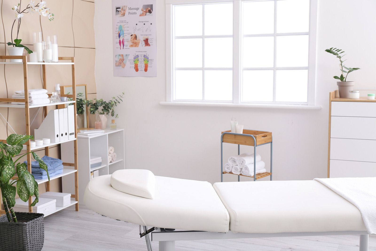 There is a massage table in the middle of the room.