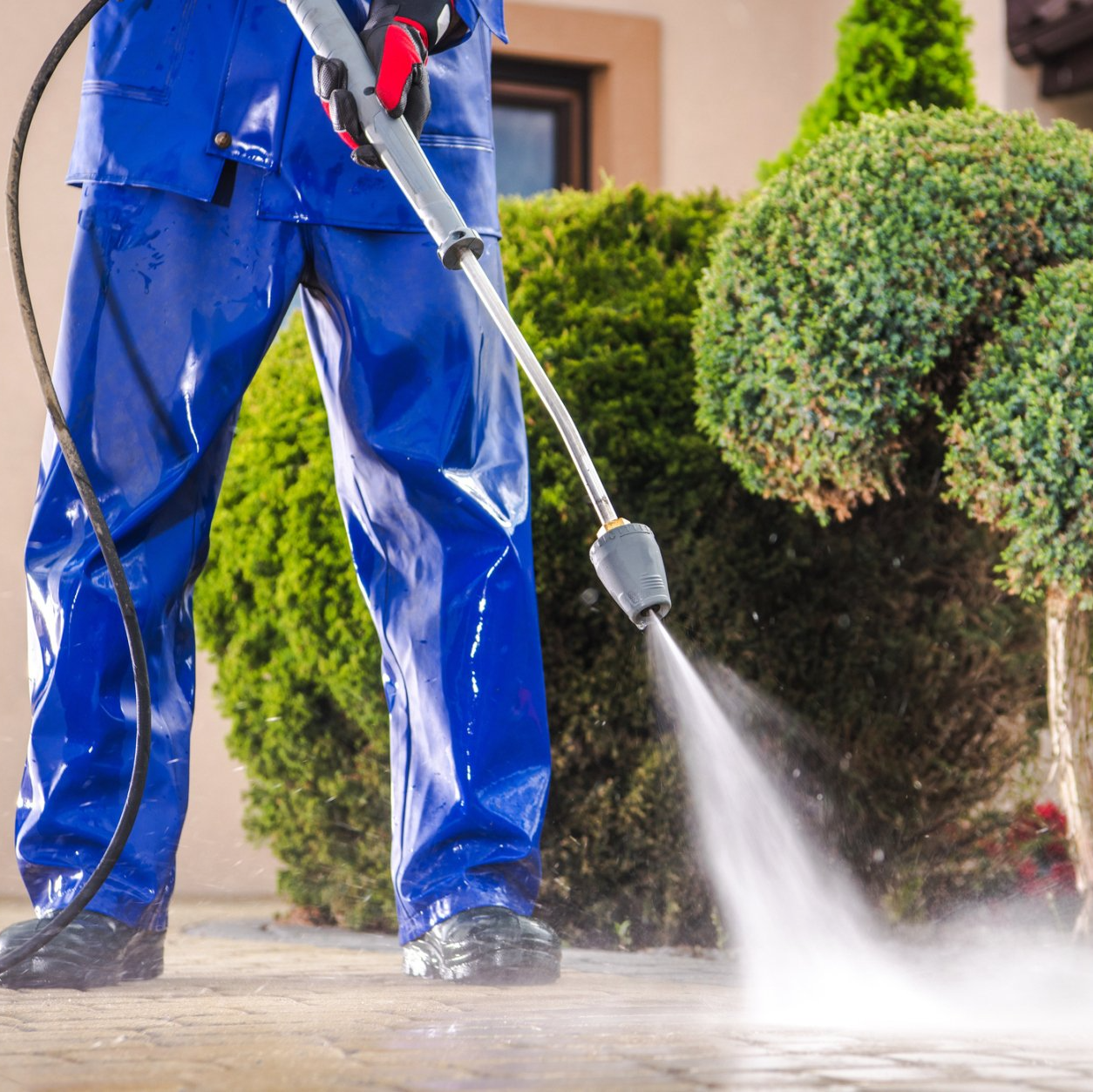 Caucasian worker cleaning residential driveway — Oldsmar, FL — Nighthawk Pressure Washing LLC