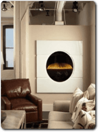 Camino di forma circolare e di fianco una poltrona