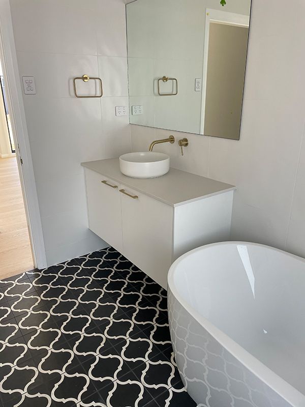 A Bathroom with A Bathtub, Sink, and Mirror — BJB Plumbing & Gasfitting in Coonabarabran, NSW