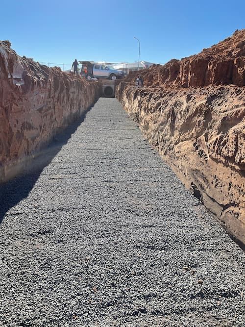 A Dirt Road with A Tunnel in The Background — BJB Plumbing & Gasfitting in Dubbo, NSW