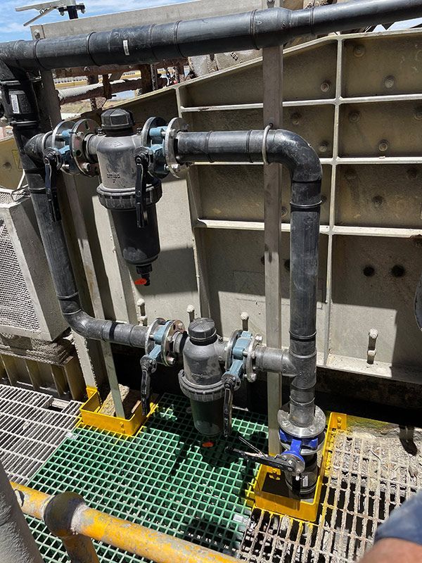 A Close Up Of A Pipe System On A Green Platform — BJB Plumbing & Gasfitting in Dubbo, NSW