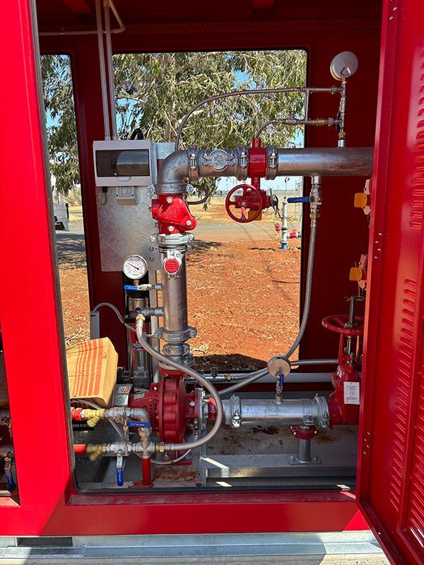 A Red Box With A Lot Of Pipes And Valves Inside Of It — BJB Plumbing & Gasfitting in Dubbo, NSW