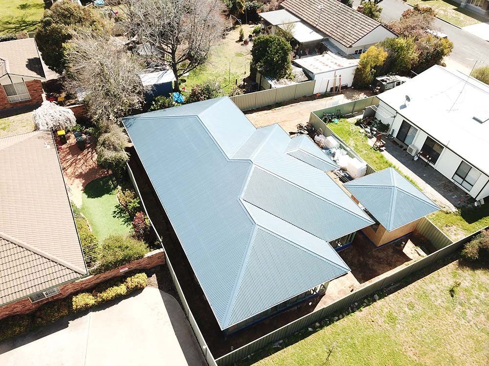 A View of A House with A Blue Roof — BJB Plumbing & Gasfitting in Coonabarabran, NSW