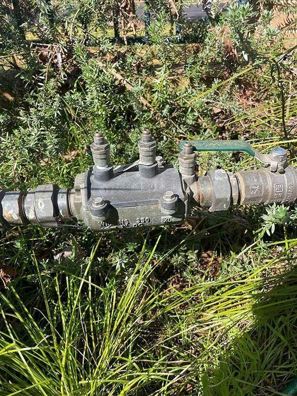 A Close Up Of A Water Valve In The Grass — BJB Plumbing & Gasfitting in Dubbo, NSW