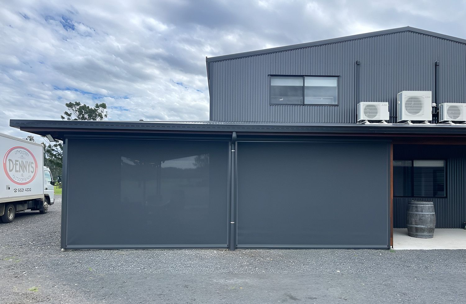 Exterior Of A Building With Dark Gray Roller Blinds