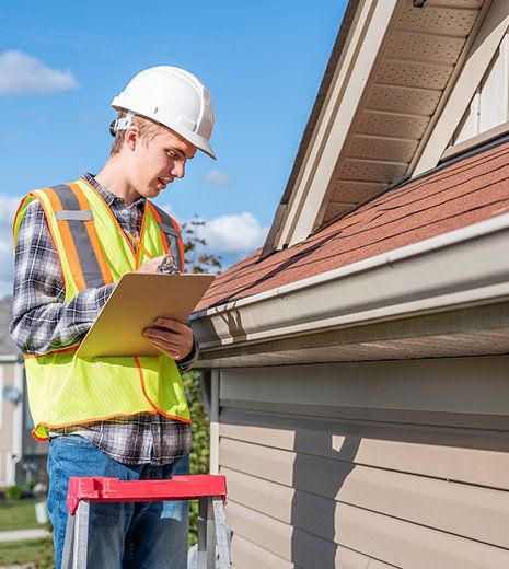 Worker Inspecting House Roof — Louisville, KY  — Quality Exteriors Group, LLC